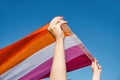 Woman waving a lesbian pride flag outdoors