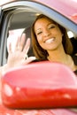 Woman waving out of car window