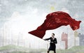 Woman waving red flag . Mixed media Royalty Free Stock Photo