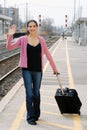 Woman waving at train station