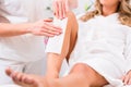 Woman at waxing hair removal in beauty parlor Royalty Free Stock Photo