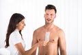 Woman Waxing Man`s Chest With Wax Strip Royalty Free Stock Photo