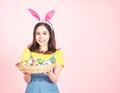 Woman wear bunny ears hold easter eggs basket Royalty Free Stock Photo