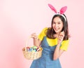 Woman wear bunny ears hold easter eggs basket Royalty Free Stock Photo