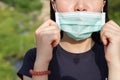 The woman wear the face mask wrong. Wearing a face mask won`t protect from contracting COVID-19