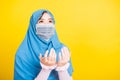 Woman wear hijab and face mask she henna decorated hands praying