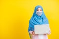 Woman wear hijab and face mask protective to prevent coronavirus she holding laptop Royalty Free Stock Photo