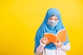 Woman wear hijab she hold book on hand and open reding it