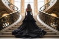 A woman wear a long black evening dress, standing on the middle of a staircase in an luxury palace