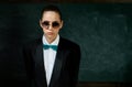 Woman wear masculine clothes tuxedo bow tie and eyeglasses. Sunglasses formal style. Girl formal jacket suit and Royalty Free Stock Photo