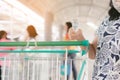 Woman wear mask using alcohol nano mist sprayer antiseptic cleaning on shopping cart trolley handle protection during Coronavirus Royalty Free Stock Photo