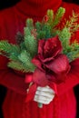 Woman wear red sweater hold christmas flower bouquet Royalty Free Stock Photo