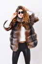 Woman wear sunglasses and hairstyle posing mink or sable fur coat. Fur fashion concept. Winter elite luxury clothes Royalty Free Stock Photo