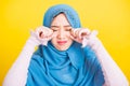 Woman wear veil hijab she sad crying using hand wiping tears in her eyes Royalty Free Stock Photo