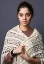 A woman wearing a beige knitted scarf