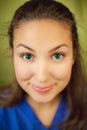 Woman wearing blue blouse with malicious smile