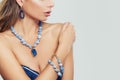 Glamorous woman wearing blue necklace, bracelet and earrings Royalty Free Stock Photo