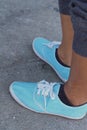 Woman wearing blue shoes at the park. Royalty Free Stock Photo