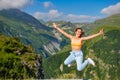 Woman Wearing Blue Suit Standing Against Breathtaking Mountain Background with Blue Sky and Trees Royalty Free Stock Photo