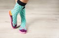 Woman wearing bright socks with flip-flops standing on floor Royalty Free Stock Photo