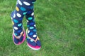 Woman wearing bright socks with flip-flops standing on grass Royalty Free Stock Photo