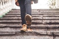 Woman wearing brown leather boots. Walking down the stairs Royalty Free Stock Photo