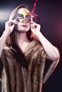 Woman wearing carnival venetian mask on blur background. Royalty Free Stock Photo