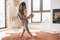 Woman wearing cashmere nightwear relaxing in cabin near fireplace Royalty Free Stock Photo