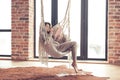 Woman wearing cashmere nightwear relaxing in cabin near fireplace Royalty Free Stock Photo