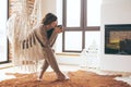 Woman wearing cashmere nightwear relaxing in cabin near fireplace Royalty Free Stock Photo