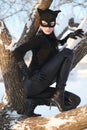 Woman wearing catsuit and mask