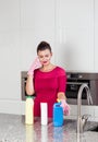 Woman wearing cleaning gloves standing in a kitchen