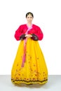 The woman wearing colorful Hanbok, Korean traditional dress on white background isolated.