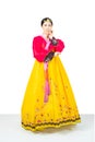 The woman wearing colorful Hanbok, Korean traditional dress on white background isolated.