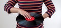 Woman wearing colorful striped clothes holding old vinyl retro record music audio on background