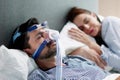 Woman wearing CPAP sleep apnea mask machine