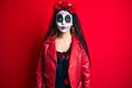 Woman wearing day of the dead costume over red puffing cheeks with funny face