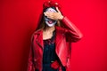 Woman wearing day of the dead costume over red smiling and laughing with hand on face covering eyes for surprise