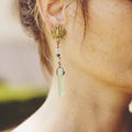 Woman wearing decorative earrings Royalty Free Stock Photo
