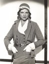 Woman wearing dress suit with matching hat