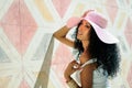 Woman wearing dress and sun hat, afro hairstyle Royalty Free Stock Photo