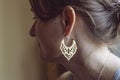 Woman wearing earrings in the shape of oriental lotus