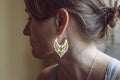 Woman wearing earrings in the shape of oriental lotus