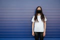 Woman wearing face mask because of Air pollution or virus epidemic in the city. ÃÅ¾n a blue background.