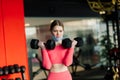 Woman wearing face mask exercise workout in gym during corona virus pandermic Royalty Free Stock Photo