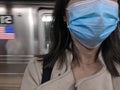 Woman Wearing Face Mask in NYC Subway Platform Taking the MTA Train New York City