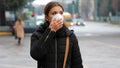 COVID-19 Pandemic Coronavirus Woman in city street wearing face mask protective for spreading of disease virus SARS-CoV-2. Girl wi