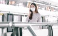 Woman wearing face mask and talking on mobile phone while standing on railway station Royalty Free Stock Photo