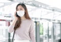 Woman wearing face mask and talking on mobile phone while standing on railway station Royalty Free Stock Photo