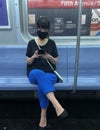 Woman Wearing Fask Mask Inside MTA Subway Car Commute New York City Train NYC Royalty Free Stock Photo